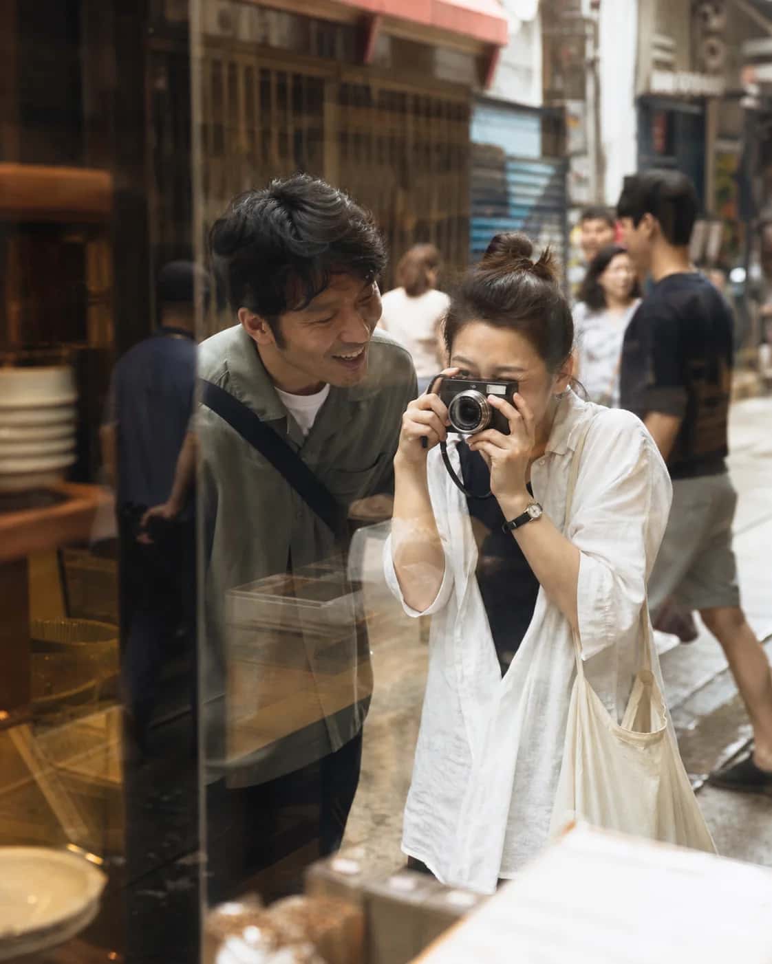Illustrative Hong Kong street-photowalk scene of two adults with a camera beginning a new conversation; not a member photo.