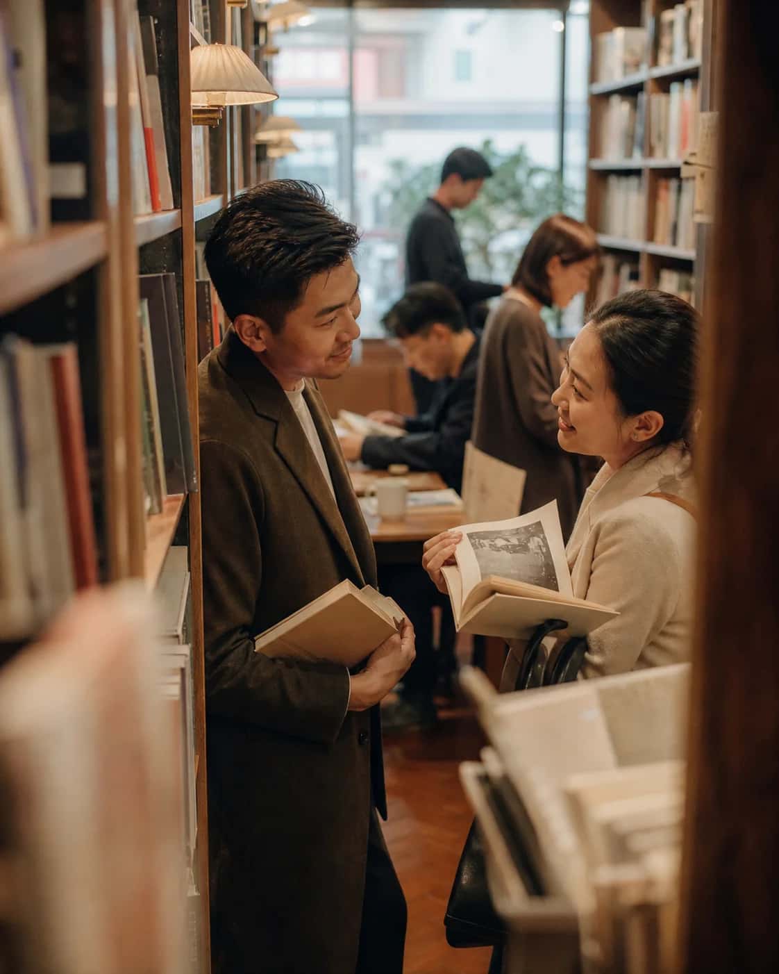 Two adults browse books together in a Hong Kong bookshop; an illustrative campaign scene, not a photo of Another Half members.