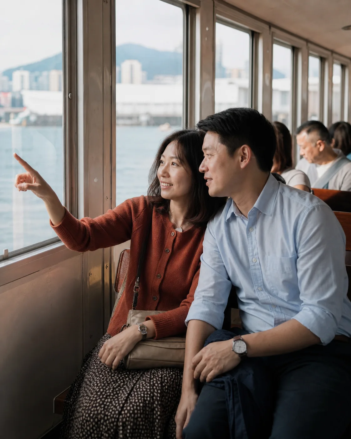 Illustrative brand scene of two adults looking towards the harbour from a ferry; not a member photo or testimonial.